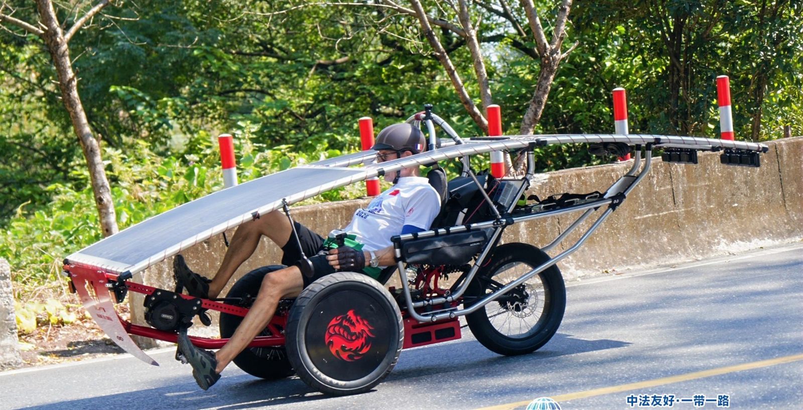 WANYU solar-powered recumbent trike on a mountain road, side view